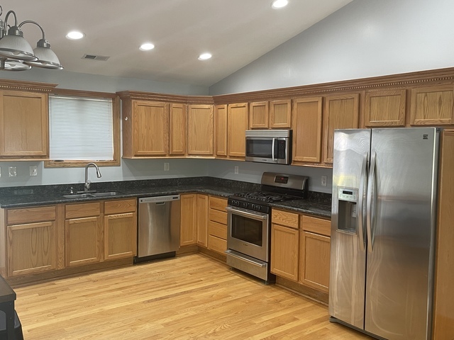 3845 McCormick Avenue Brookfield, IL 60513 - Photo 4 of 6 a kitchen with stainless steel appliances granite countertop a refrigerator sink and cabinets