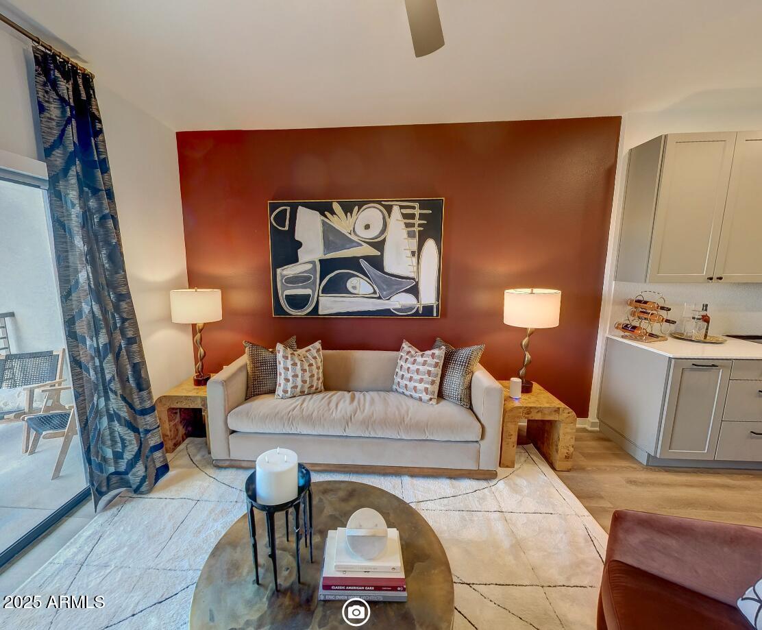 1225 North Arizona Avenue, Unit A2 1 Gilbert, AZ 85233 - Photo 2 of 17 a living room with furniture and a painting on the wall