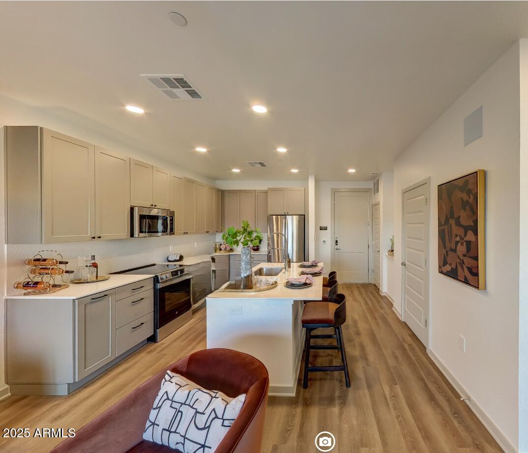 1225 North Arizona Avenue, Unit A2 1 Gilbert, AZ 85233 - Photo 3 of 17 a large kitchen with a table and chairs in it