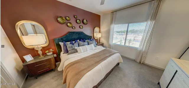 a bed sitting in a bedroom next to a window