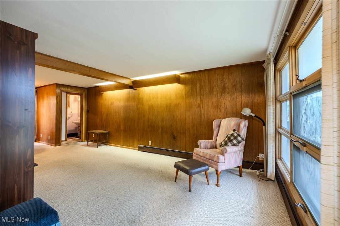 1950 Rush Road Wickliffe, OH 44092 - Photo 49 of 50 Living area with beam ceiling, carpet floors, wood walls, and baseboard heating