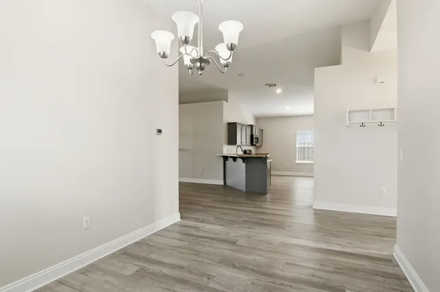 a view of a kitchen with a cabinet and a chandelier