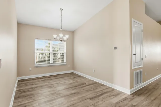 a view of a room with window entryway and wooden floor