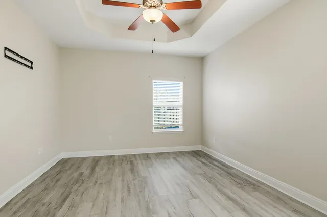 a view of room with window and hardwood floor