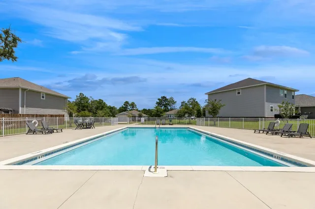 a view of swimming pool with outdoor seating