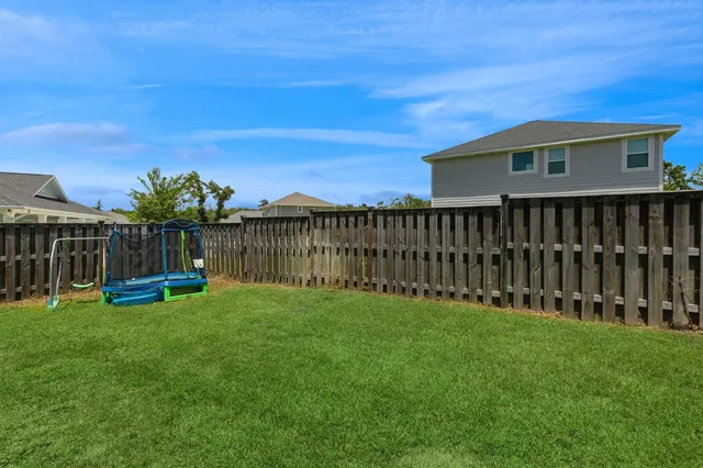 a view of a chair and table with wooden fence