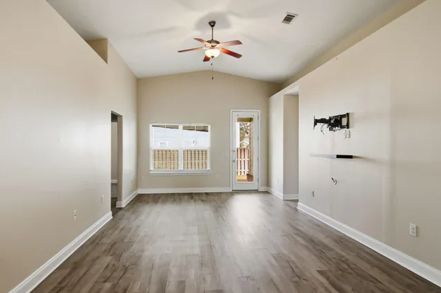 wooden floor in an empty room with a window