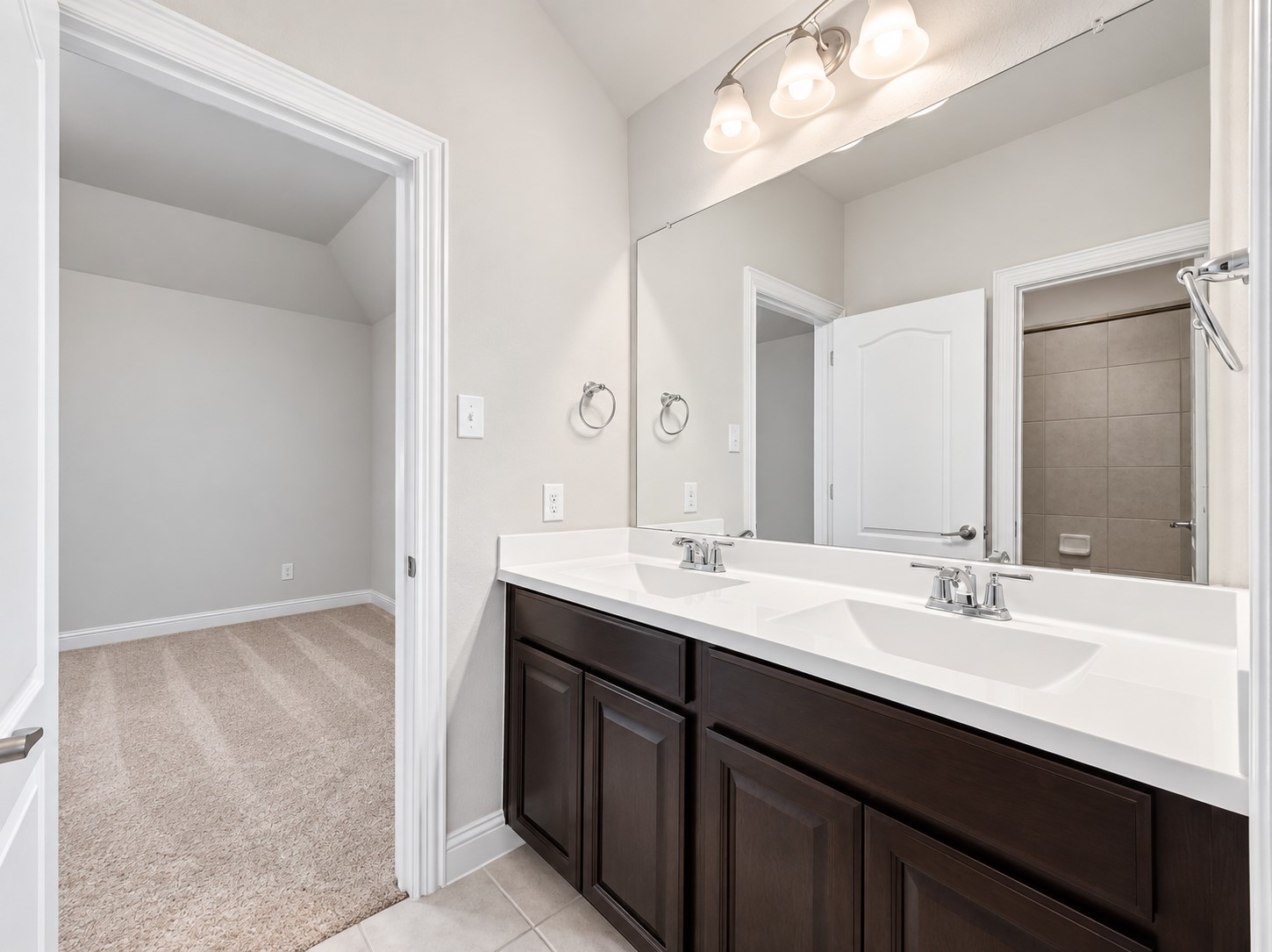 9626 Invergarry Way Tomball, TX 77375 - Photo 36 of 43 Jack-and-Jill bathroom connects two secondary bedrooms and features a dual-sink vanity with generous counter and cabinet space. Also has a tub/shower combo.