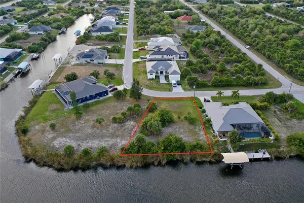 an aerial view of a house with a garden and lake view