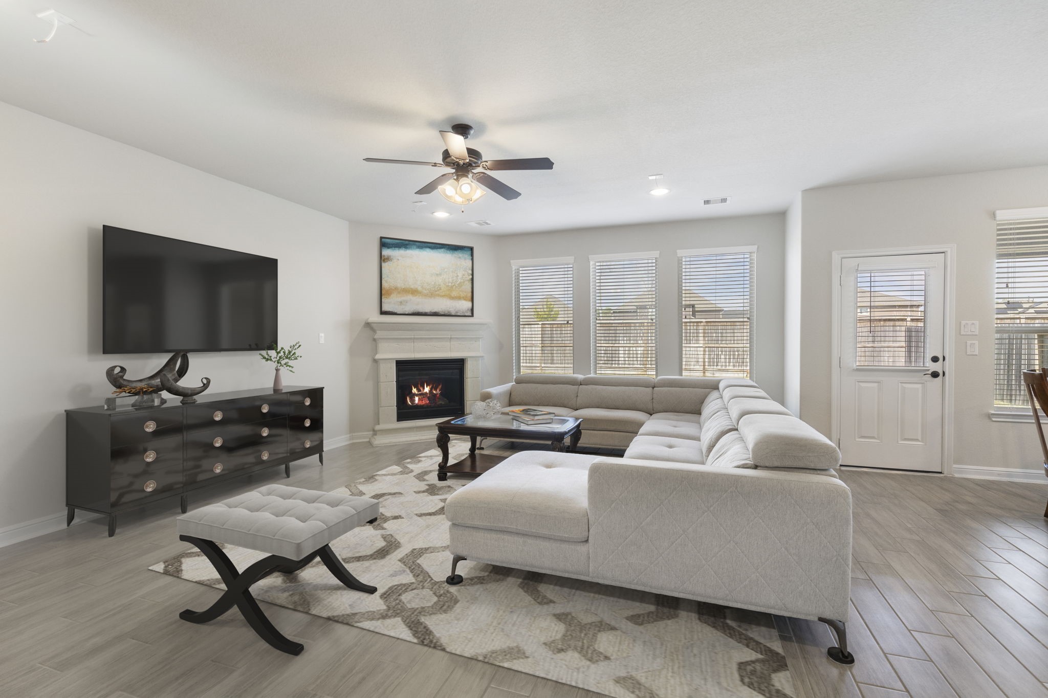 2819 Bradbury Hills Road Spring, TX 77373 - Photo 17 of 50 Experience modern elegance in this virtually staged living room, featuring a cozy fireplace, abundant natural light, and sleek design elements perfect for stylish gatherings.