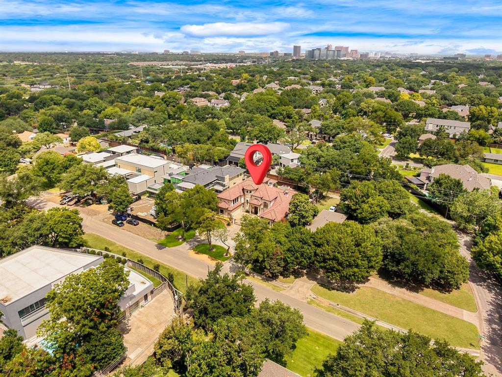 5821 Northaven Road Dallas, TX 75230 - Photo 38 of 40 Aerial perspective showcasing a residential property with a multi-level structure and a tile roof, surrounded by mature trees