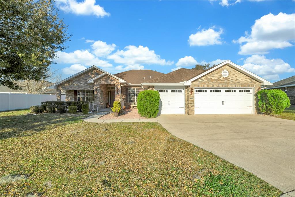 a view of a house with a yard and garage