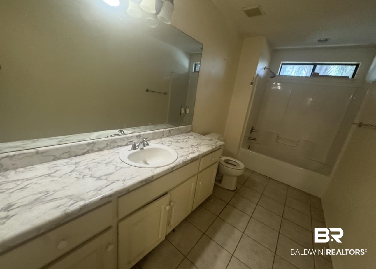 23341 County Road 49 Silverhill, AL 36576 - Photo 11 of 23 Bathroom featuring vanity, shower combination, and light tile patterned floors