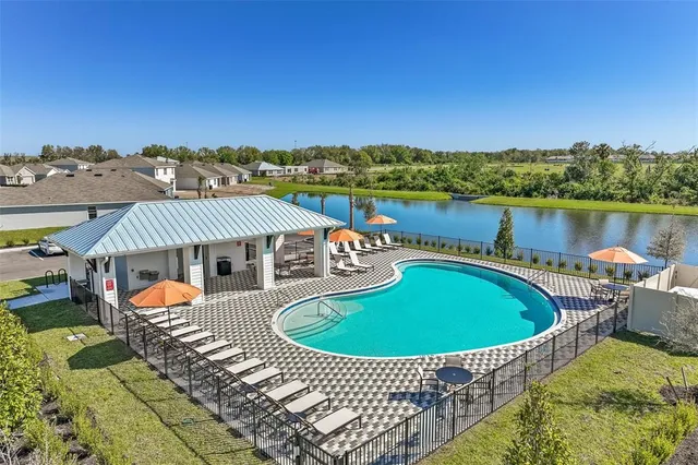 an outdoor sitting area with a lake view