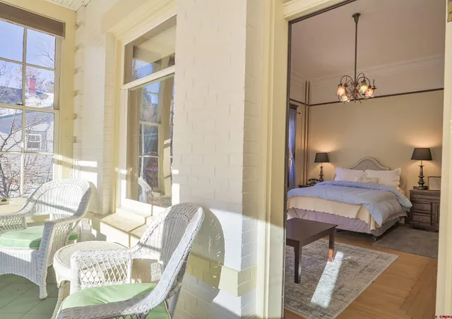 a living room with furniture and a floor to ceiling window