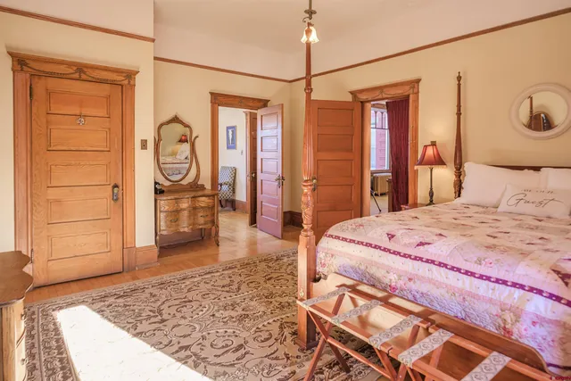 a bed room with a bed and a dresser