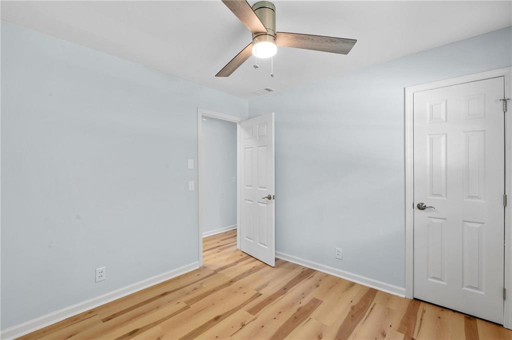 1745 Rockbridge Road Northwest Conyers, GA 30012 - Photo 16 of 32 a view of empty room with wooden floor