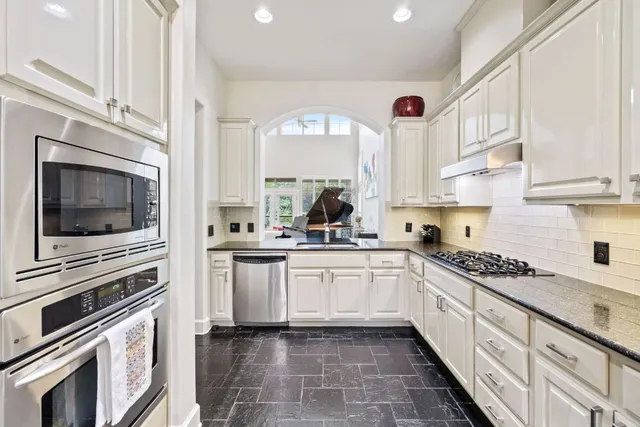 a kitchen with a stove a sink and a microwave