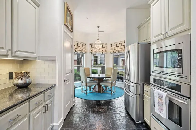a kitchen with stainless steel appliances a sink a stove and refrigerator