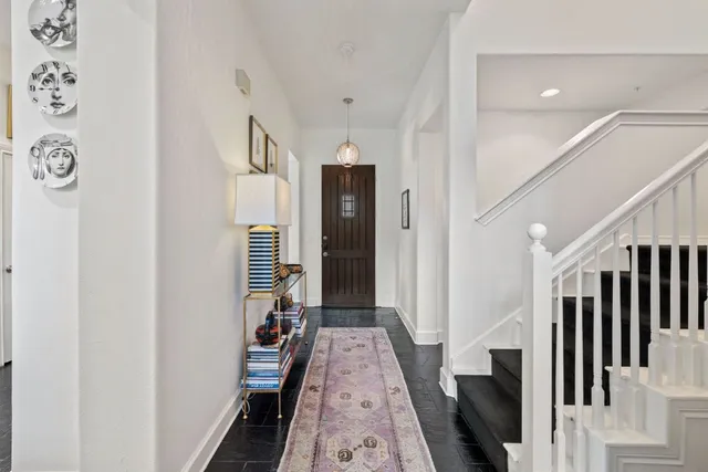 a view of hallway with stairs and wooden floor