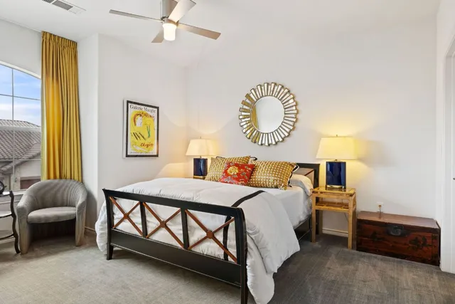 a bedroom with a bed and a window