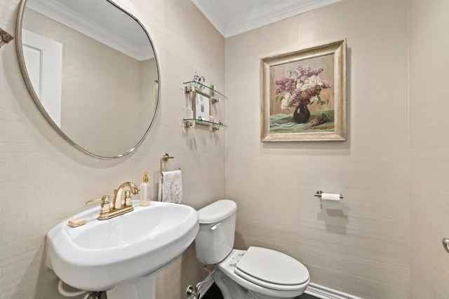 a bathroom with a toilet a sink and a mirror