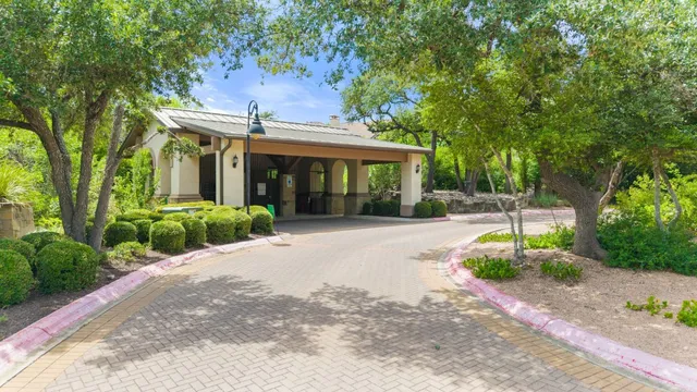 a front view of a house with a yard and potted plants