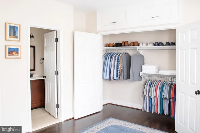 a bedroom with a bed and a table in it with wooden floor