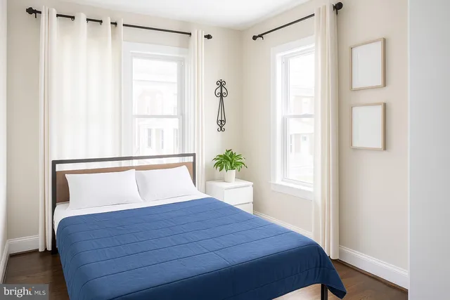 a large bed in a bedroom with a lamp