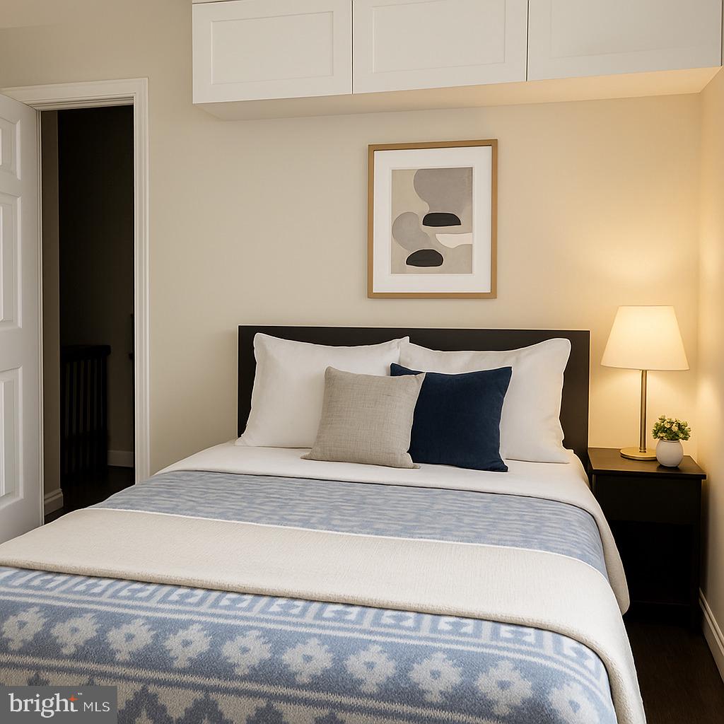 749 Gresham Place Northwest Washington, DC 20001 - Photo 16 of 20 a large bed in a bedroom with a lamp