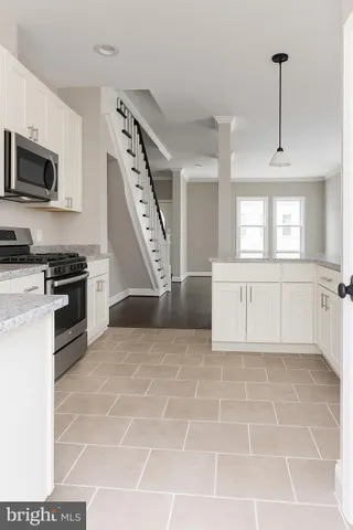 a view of a kitchen with microwave and cabinets