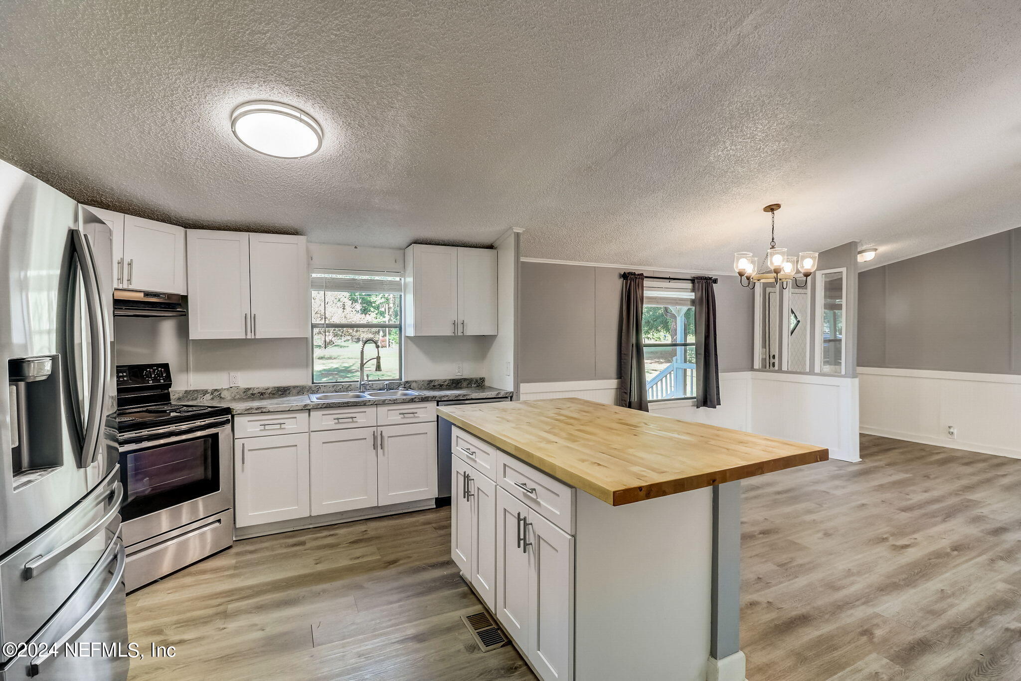 54262 Vikki Road Callahan, FL 32011 - Photo 14 of 48 a kitchen with granite countertop a sink stove and refrigerator