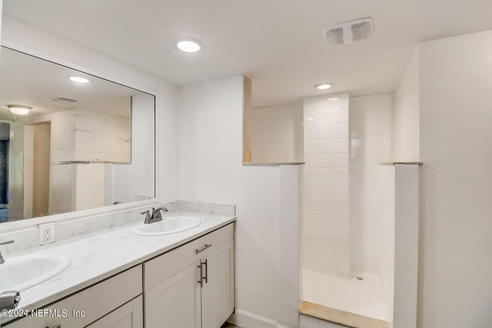 54262 Vikki Road Callahan, FL 32011 - Photo 19 of 48 a bathroom with a double vanity sink and a mirror