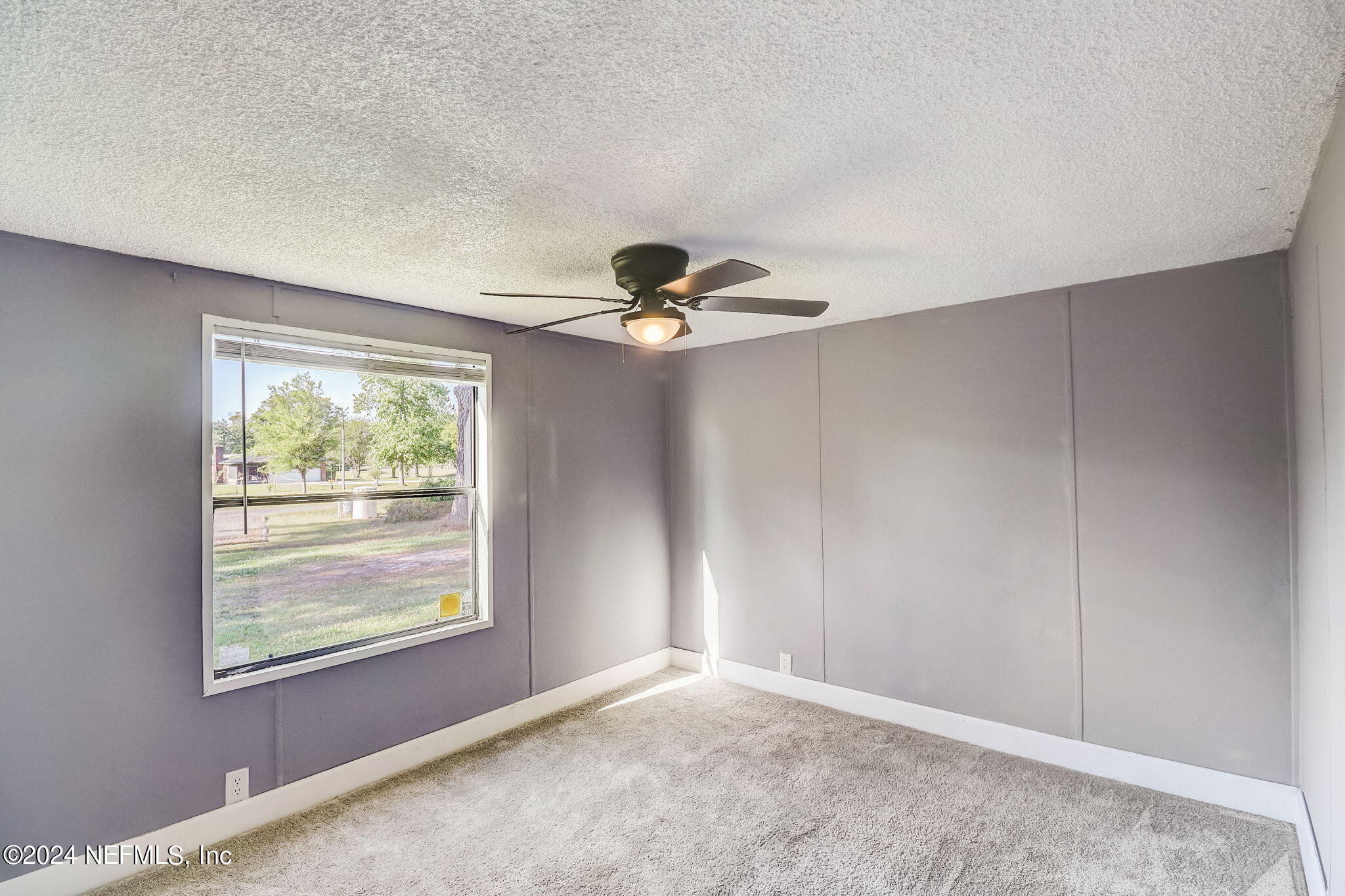 54262 Vikki Road Callahan, FL 32011 - Photo 23 of 48 wooden floor in an empty room with a window