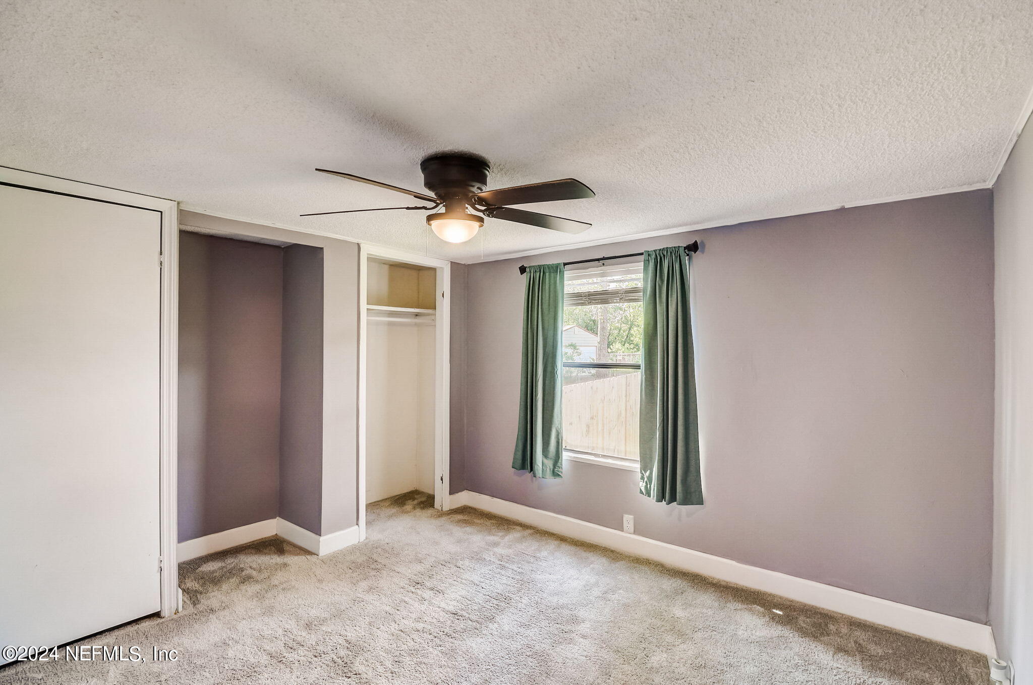 54262 Vikki Road Callahan, FL 32011 - Photo 26 of 48 an empty room with windows and fan