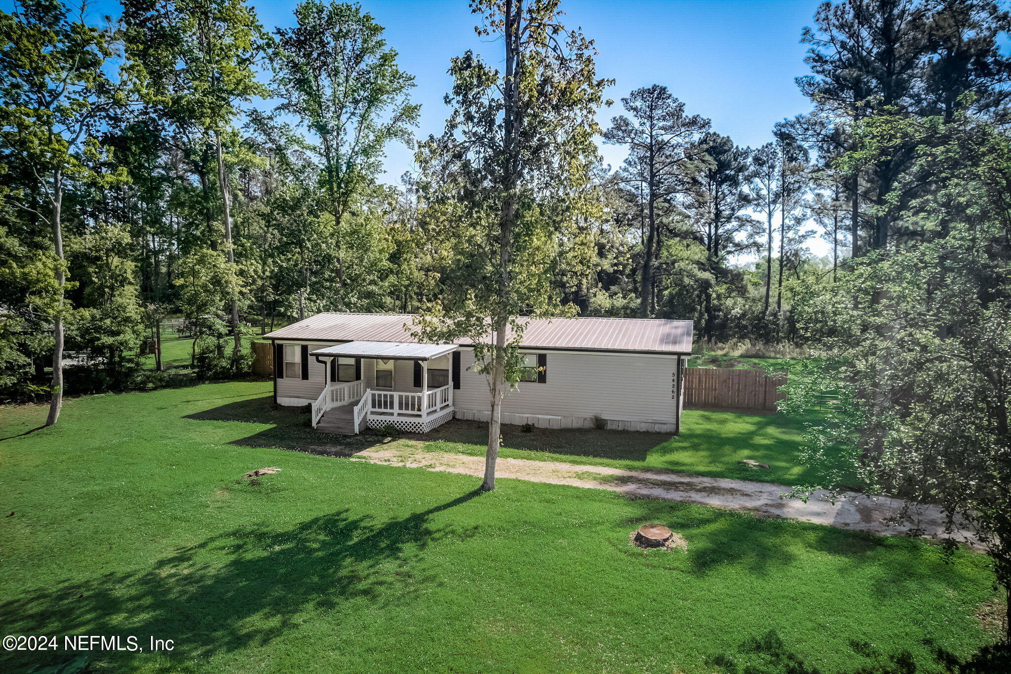 54262 Vikki Road Callahan, FL 32011 - Photo 41 of 48 a view of a house with a backyard and a patio