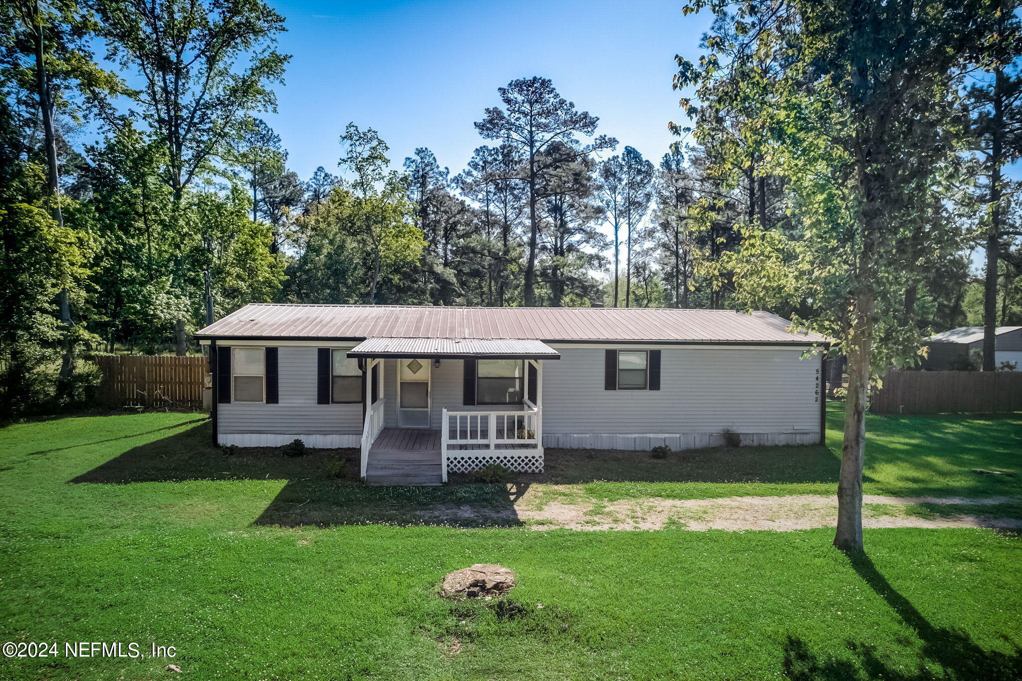 54262 Vikki Road Callahan, FL 32011 - Photo 42 of 48 a view of a house with a yard porch and sitting area
