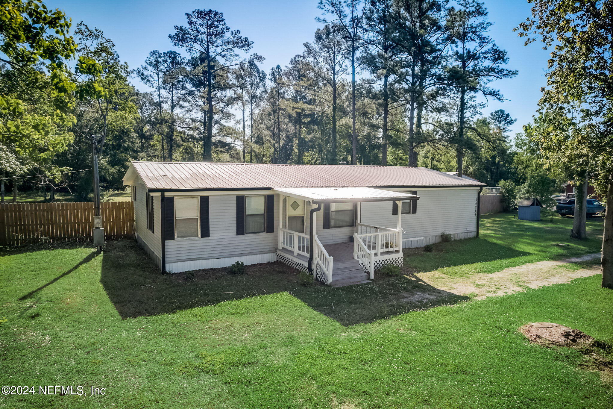 54262 Vikki Road Callahan, FL 32011 - Photo 43 of 48 a view of a house with backyard and sitting area
