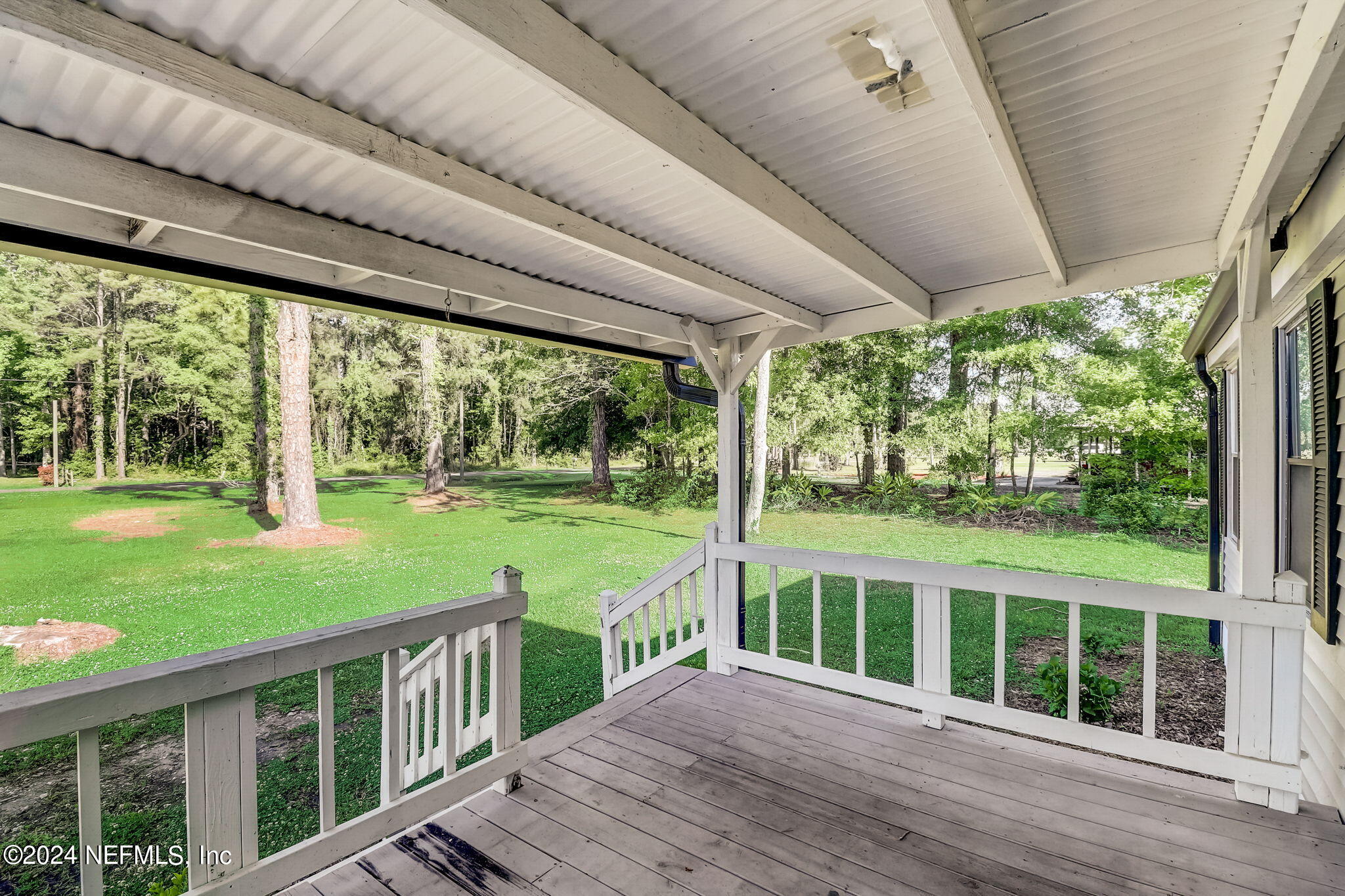 54262 Vikki Road Callahan, FL 32011 - Photo 5 of 48 a view of a deck with a big yard potted plants and floor to ceiling window