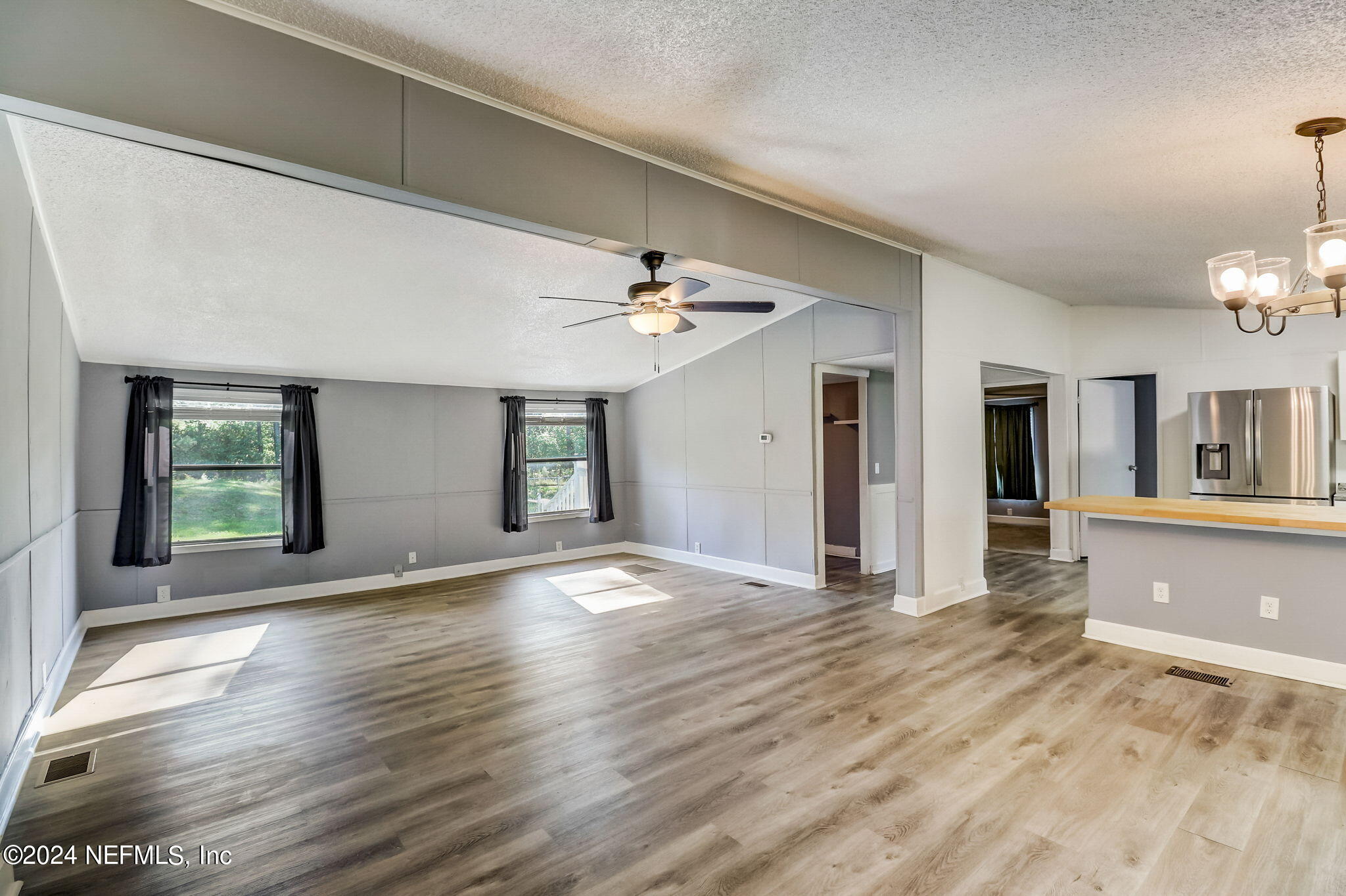 54262 Vikki Road Callahan, FL 32011 - Photo 8 of 48 a view of a livingroom with wooden floor and a kitchen