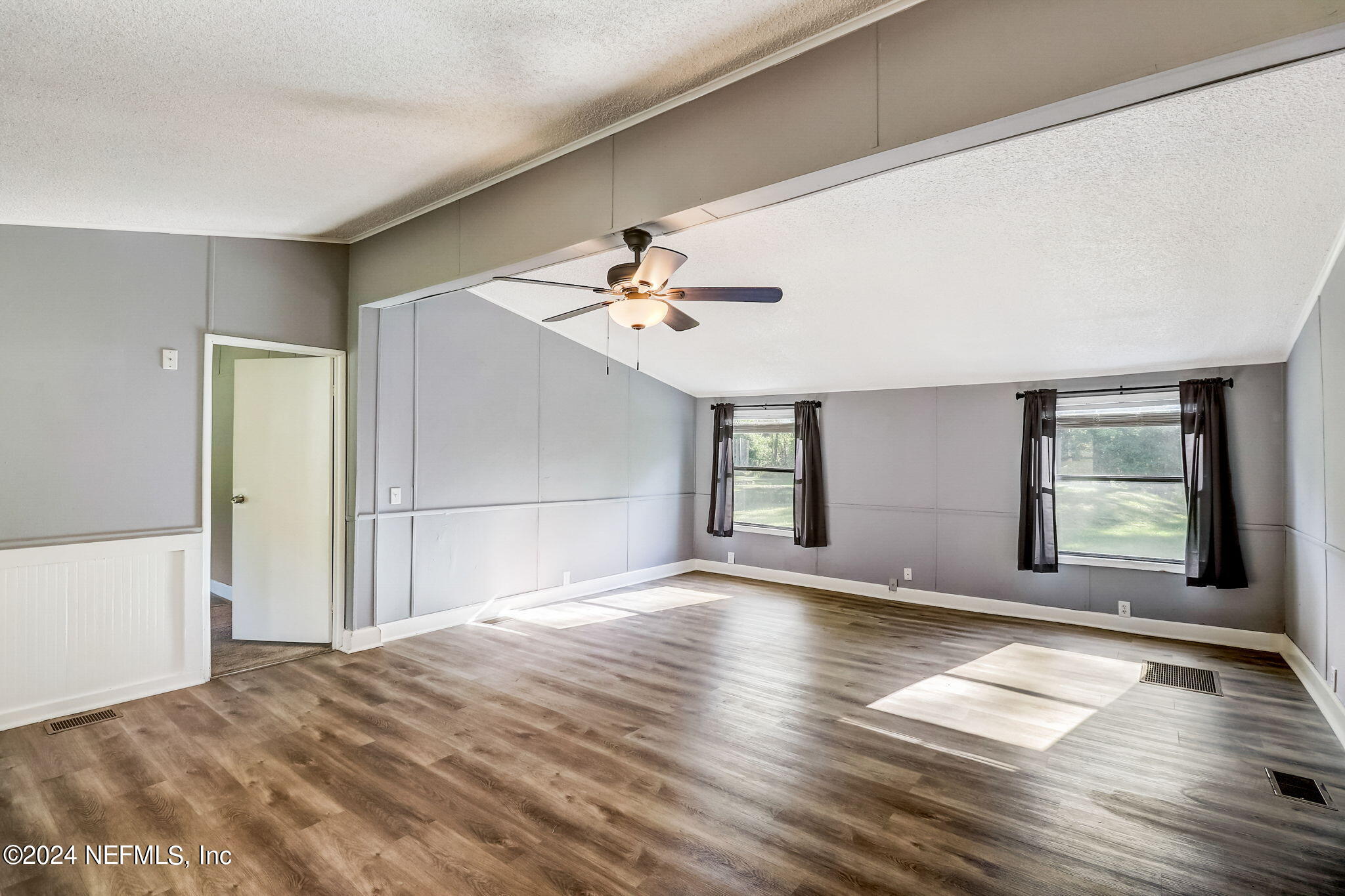 54262 Vikki Road Callahan, FL 32011 - Photo 9 of 48 a view of a livingroom with wooden floor and a ceiling fan