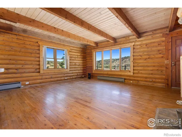 a view of a room with wooden floor and window