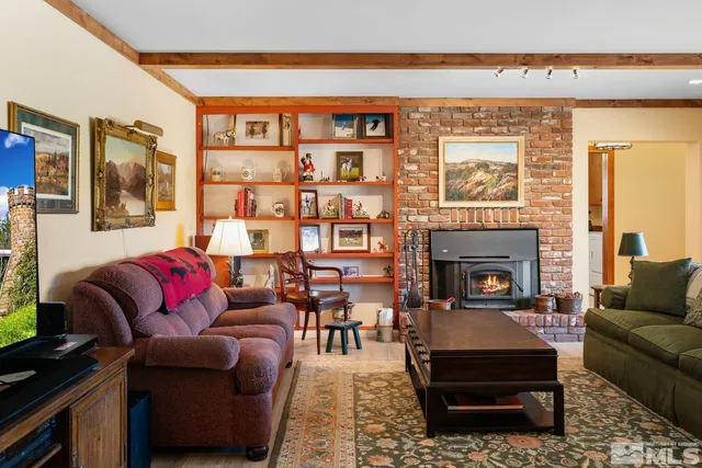 a living room with furniture a wooden floor and a ceiling fan