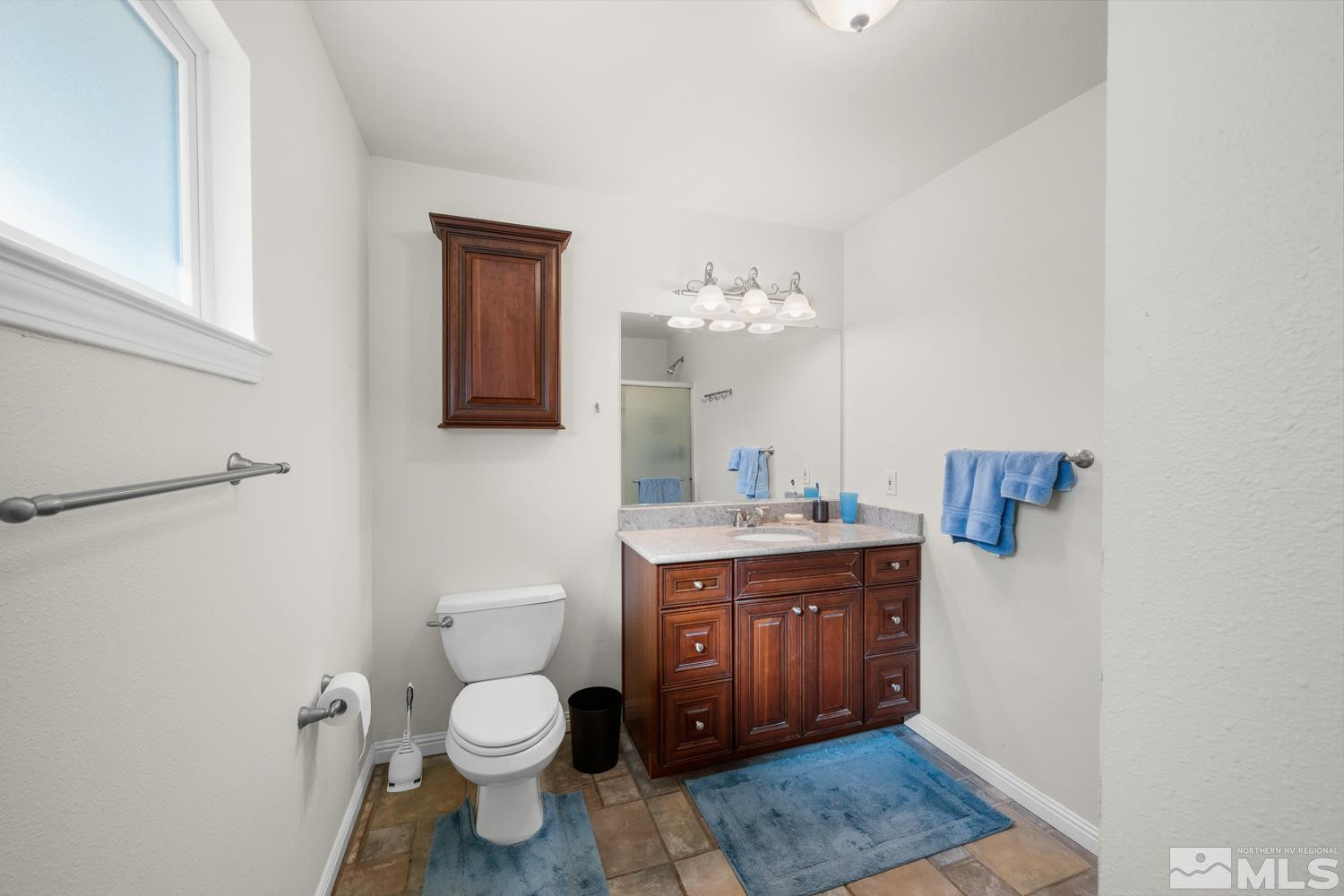 14005 North Red Rock Road Reno, NV 89508 - Photo 28 of 39 a spacious bathroom with a toilet a sink and mirror