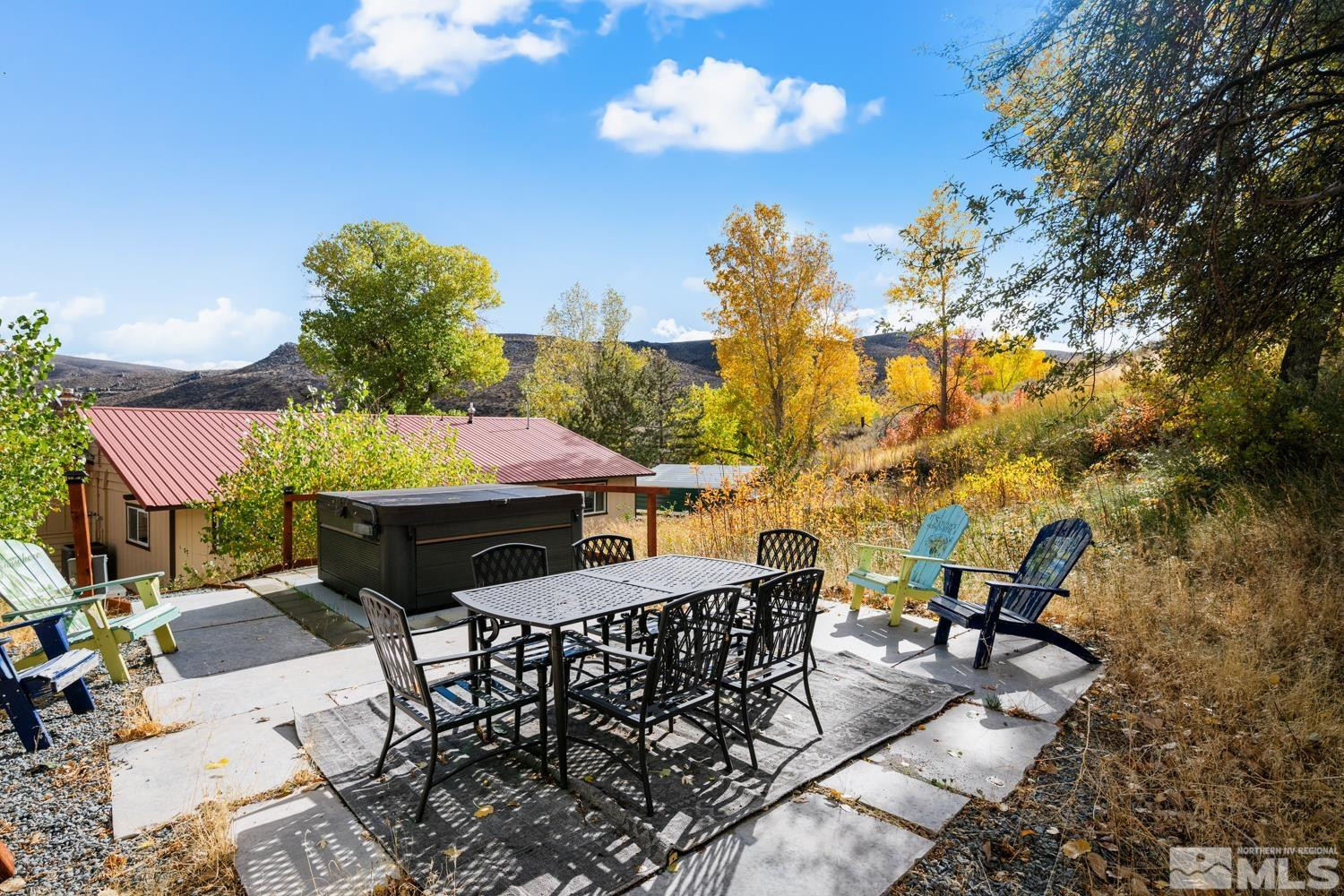14005 North Red Rock Road Reno, NV 89508 - Photo 10 of 39 a view of a patio with table and chairs with wooden floor and fence