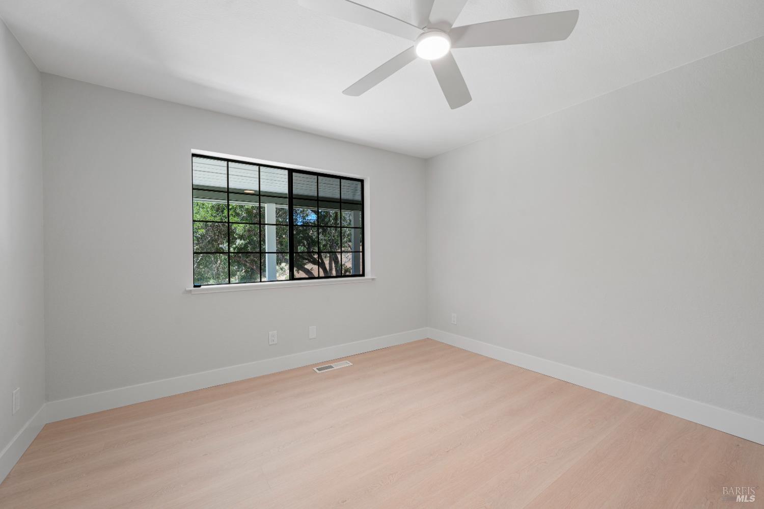 2129 Rockville Road Fairfield, CA 94534 - Photo 31 of 59 an empty room with a window and a fan