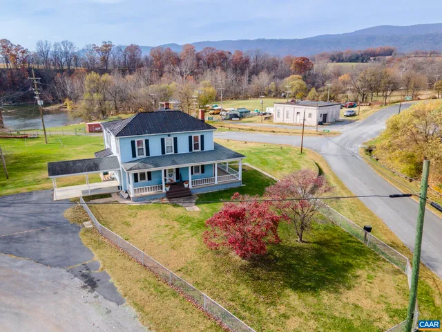 an aerial view of a house with a swimming pool