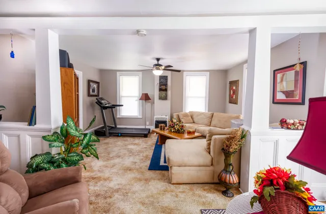 a living room with furniture and a chandelier