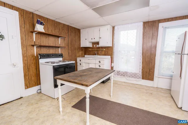 a living room with a bed furniture and a window