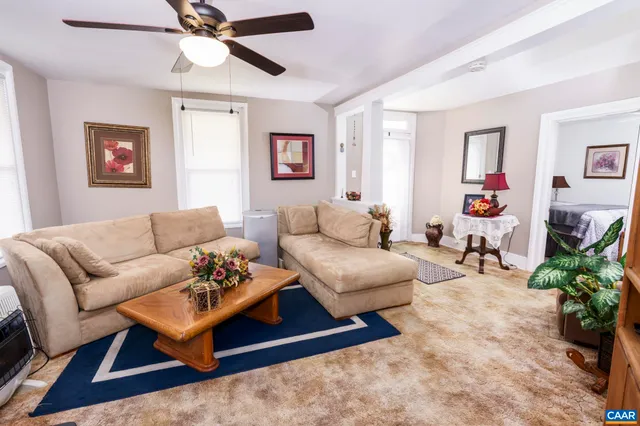a living room with furniture and wooden floor